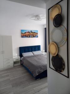 a bedroom with a blue bed and a mirror at Studio Acasă in Sibiu