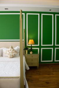 a bedroom with a bed with a green wall at Dileep Kothi - A Royal Boutique Luxury Suites in Jaipur in Jaipur