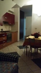 a kitchen with a table and a dining room at B&B La Salghè in Argenta