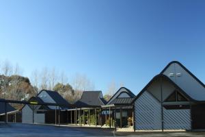 a group of buildings with black roofs at Rosebank Lodge in Balclutha