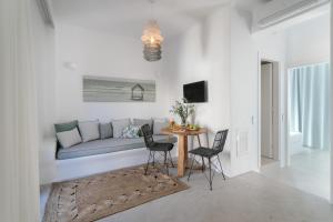 a living room with a couch and a table at Anamnesia boutique apartments Naxos town in Naxos Chora