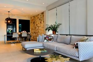 a living room with a couch and a table at Hotel Osam - Adults Only in Supetar