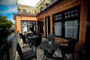 a patio with tables and chairs on a balcony at World Hostel - Old Town in Gdańsk