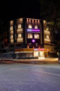 a building with a sign on the side of it at Hotel Alka Inn in Ahmedabad
