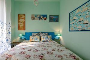 a bedroom with a large bed with blue walls at Casa Erica in Stintino