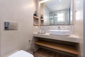 a bathroom with a sink and a mirror at Sea View in Paleokastritsa +37 photos