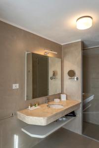 a bathroom with a sink and a mirror at Chiostro dei Domenicani - Dimora Storica in Lecce