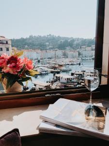 a table with a window with a view of a harbor at Vila Piranesi Apartments - Parking included in Piran
