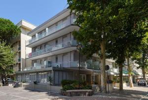 a large building with balconies on the side of it at Hotel Arno in Misano Adriatico