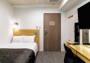 Postel nebo postele na pokoji v ubytování APA Hotel Kamata Ekimae
