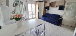 a kitchen and living room with a blue couch at Alery apartment with terrace AC wifi 7th floor a few meters from the sea by Affitto-Nizza in Nice