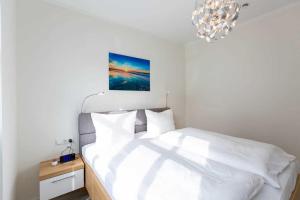 En eller flere senge i et værelse på Quartier Frohsinn App 03