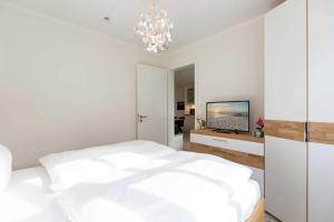 En eller flere senge i et værelse på Quartier Frohsinn App 03