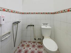 a bathroom with a toilet and a shower at OYO 90451 Hotel Roda Mas 1 in Purwokerto