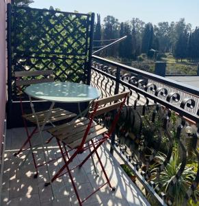 a table and chairs sitting on a balcony at Casa Giulia in Catania