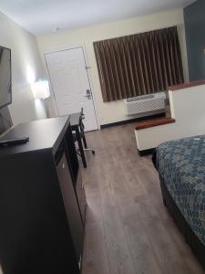 ein Hotelzimmer mit einem Bett, einem Schreibtisch und einem Zimmer in der Unterkunft Econo Lodge Inn & Suites Downtown San Antonio Riverwalk Area in San Antonio