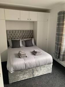 a bed with two towels on it in a bedroom at In the heart of Inverness in Inverness