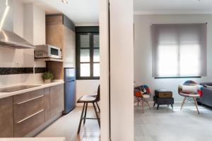 a kitchen with a sink and a refrigerator at Dream Apartments calle Zaragoza in Seville