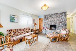 a living room with a couch and a stone fireplace at Driftwood in Cannon Beach