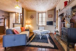 Cercy-la-TourにあるLa Maison du Meunierのソファとテーブルのあるリビングルーム