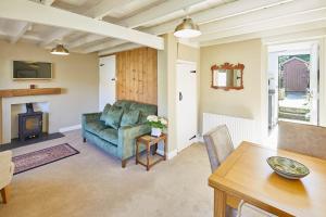 a living room with a couch and a table at Host & Stay - Holmlea Cottage in Lockton