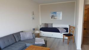 a living room with a couch and a bed at Ferienwohnung Bockholm Appartement 1 - 8 in Glücksburg