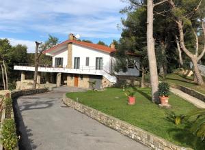 a large white house with a driveway at Il Lampin B&B in Marina di Andora