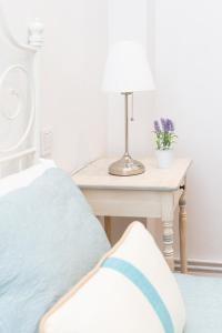 a bedroom with a bed and a table with a lamp at Old Town by Bilbao Living in Bilbao