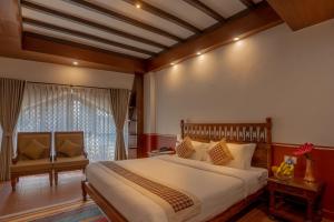 A bed or beds in a room at Pahan Chhen - Boutique Hotel