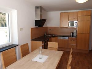 a kitchen with a table with a vase on it at Apartment Altes Zollhaus-4 by Interhome in Nauders