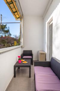 a small balcony with two chairs and a table at Apartman Jasmina 2 in Rijeka