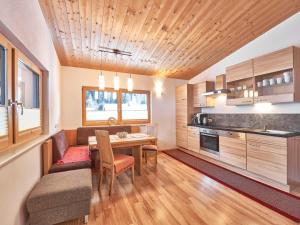 a kitchen and dining room with a wooden ceiling at Apartment Agnesn-2 by Interhome in Längenfeld