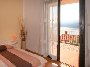 a bedroom with a bed and a view of a balcony at Apartment Katarina - RAC174 by Interhome in Rabac