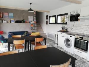 a kitchen and dining room with a table and chairs at Les Perluètes - Chambres d'hôtes in Carennac