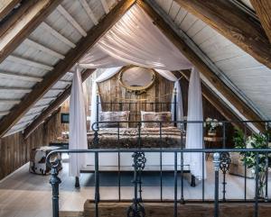a room with a bed in a attic at RESORT KOVÁRNA - Frýdštejn - stylové ubytování, luxusní wellness, zážitková restaurace in Hodkovice nad Mohelkou
