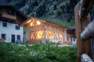 a building with a large window on the side of it at Kaser Premium Chalet am Berg in Neustift im Stubaital