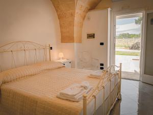 Säng eller sängar i ett rum på Masseria Tenuta Quintino