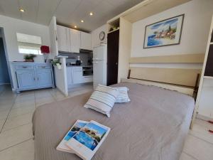 une chambre avec un lit avec un livre dessus dans l'établissement Apartment De la Plage-1 by Interhome, à Cavalaire-sur-Mer