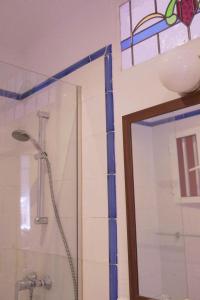 
a bathroom with a shower, sink, and mirror at Hotel Madreselva in Los Caños de Meca
