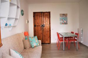 a living room with a couch and a table at Casa Luce Sabaudia in Sabaudia