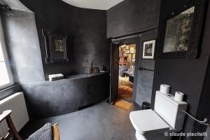 a bathroom with a white toilet and a sink at Château de Clemency in Clemency