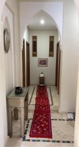 a hallway with a red rug on the floor at Villa Gardens in Douar Soukkane