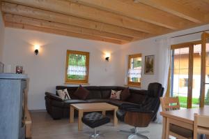 sala de estar con sofá y mesa en Feriendorf Via Claudia Haus 62 Bernhard, en Lechbruck