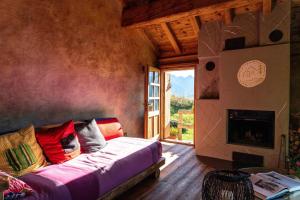 a bedroom with a bed and a fireplace and a window at Chalet Panorama Res Albert in San Guglielmo