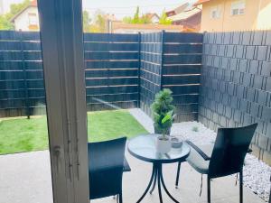 a patio with a table and chairs and a fence at Oasis of Energy in Ljubljana