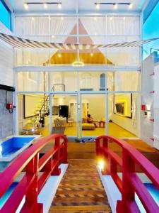 a large room with a red railing in a house at Luxury Villa Belvedere Bali in Seminiak in Legian