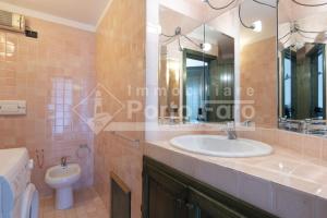 a bathroom with a sink and a toilet at 18 BAIA FARO - Grazioso bilocale mansardato a Baia del Faro in Palau