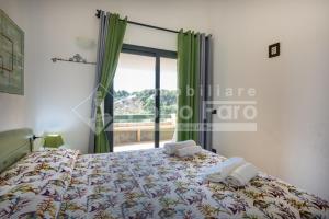 a bedroom with a bed with two towels on it at 18 BAIA FARO - Grazioso bilocale mansardato a Baia del Faro in Palau