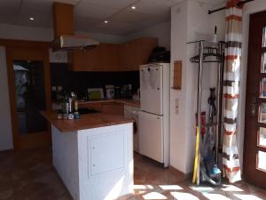 a kitchen with a white refrigerator and a counter at Haus Rosi Einliegerwohnung in Weiskirchen