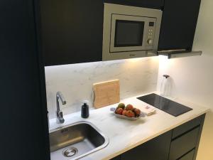 blat kuchenny ze zlewem i miską owoców w obiekcie Acogedor Estudio suite en urbanización tranquila w mieście Famara +2 zdjęcia
